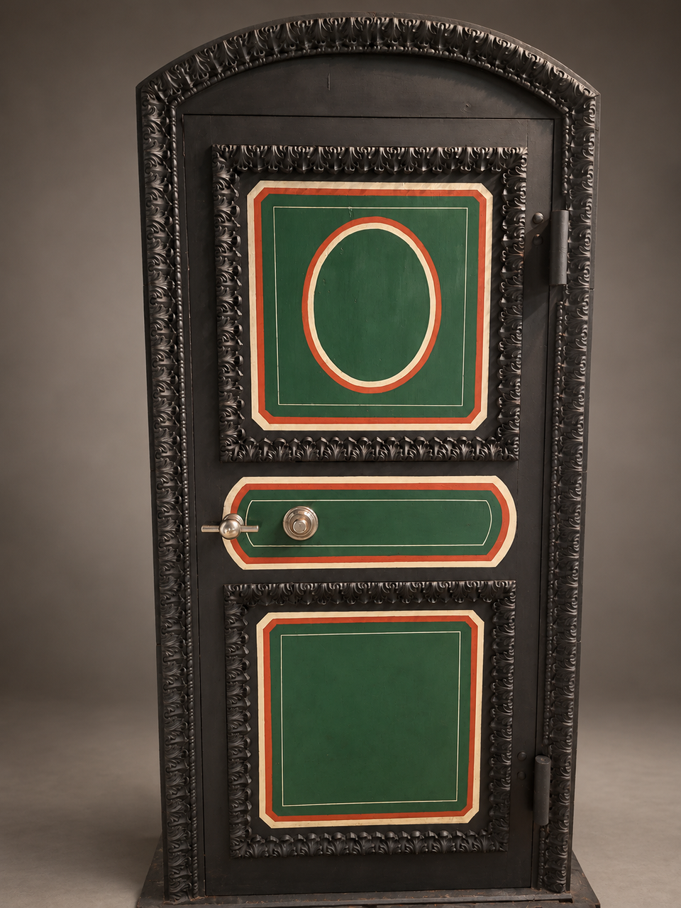 Restored Hall's vault entrance with an arched foliate surround, painted decorative panels, dial and handle.