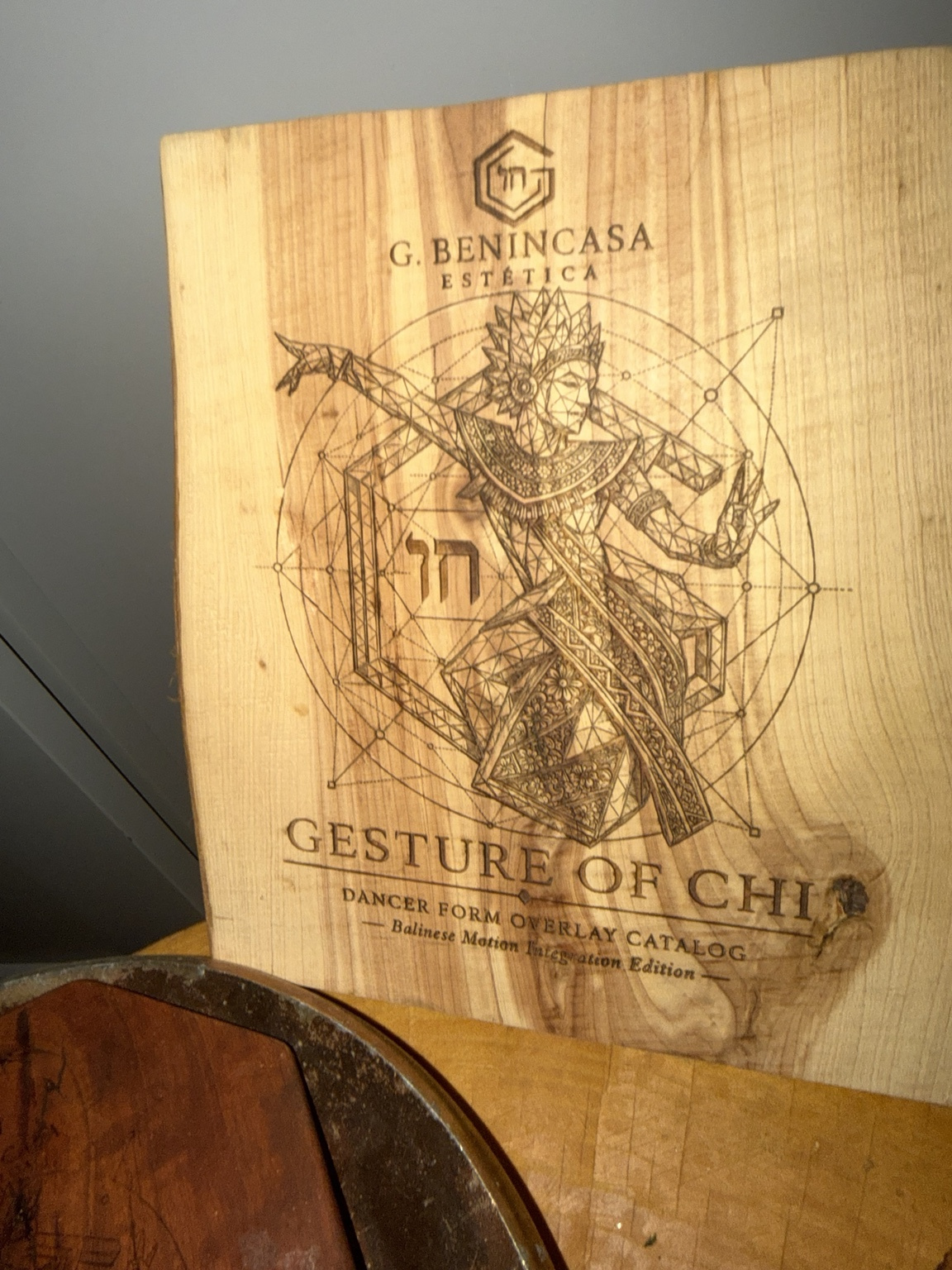 An engraved figurative artwork on timber, with the board’s grain visible through the fine lines.