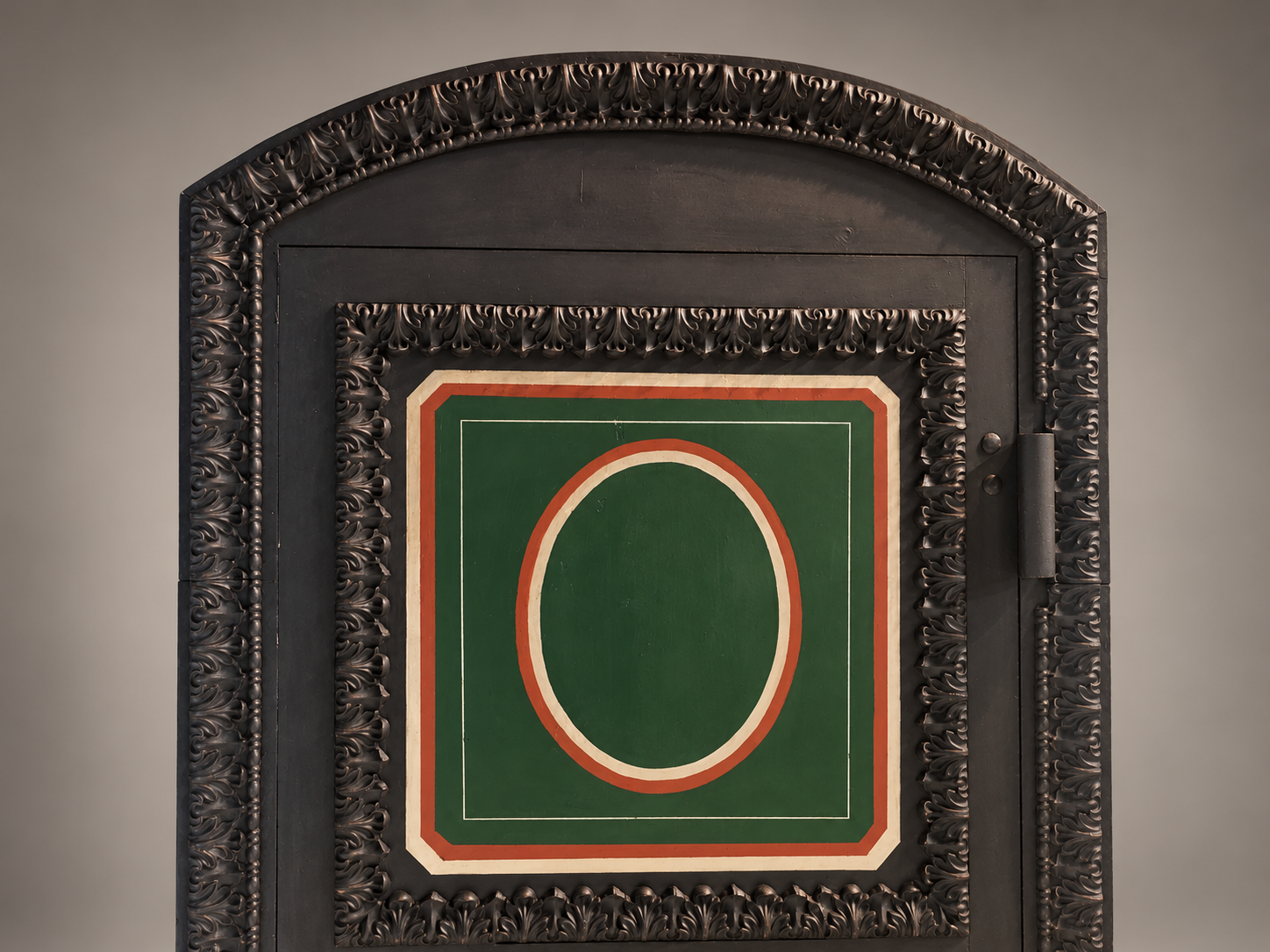 Close view of the Hall's vault's foliate arch, upper oval panel and painted decorative borders.